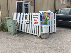 Pretty picket fence hiding compost bins