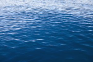 Blue lake water with small ripples