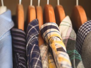 Man's closet. Hangers with shirts closeup. Male wardrobe